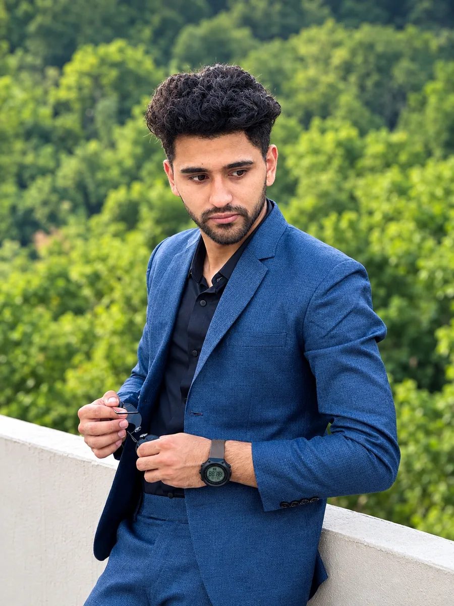 Vishal Bhattarai in a blue blazer among green foliage