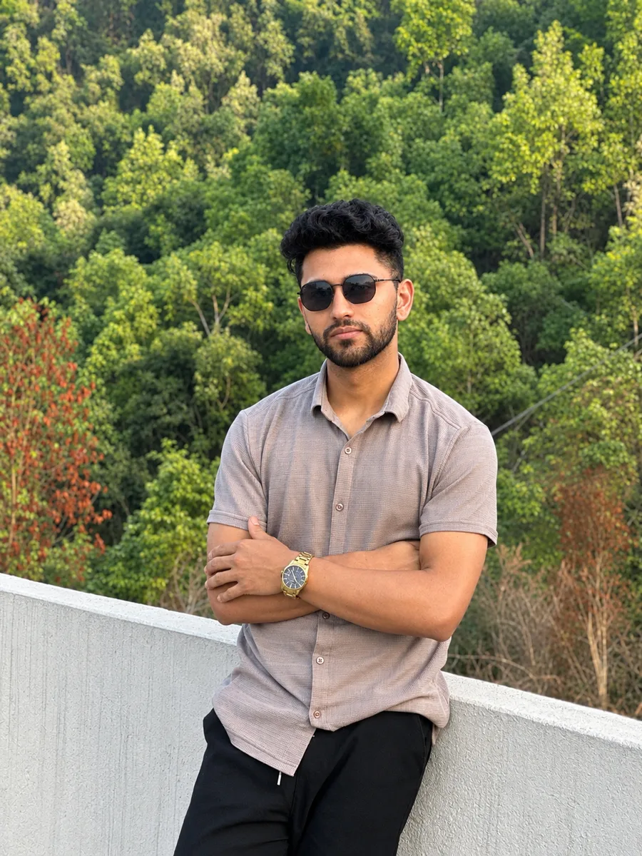 Vishal Bhattarai in sunglasses against a forest backdrop