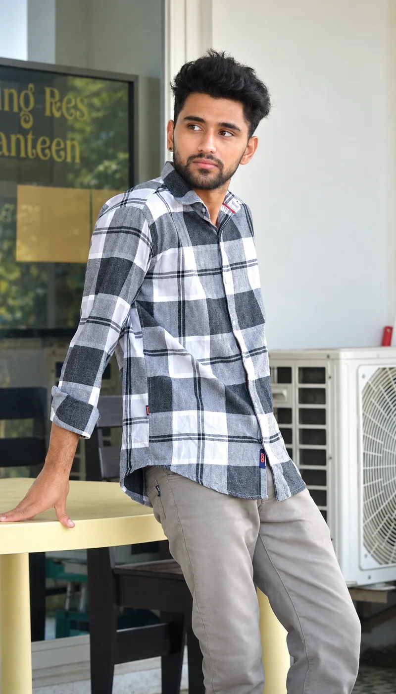 Vishal Bhattarai in a plaid shirt and chinos